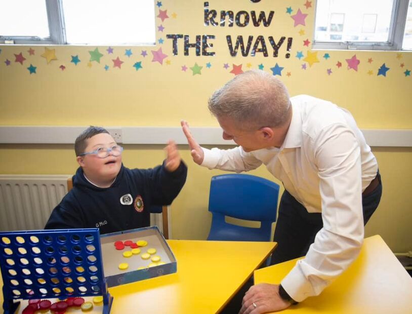 Chris Quinn giving a high five at a table