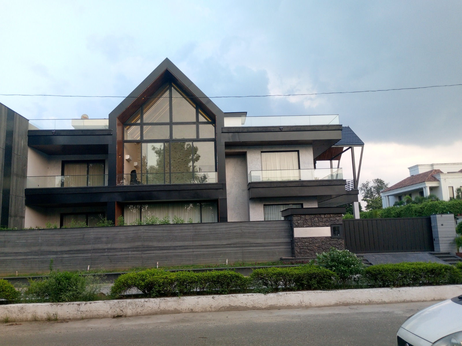 Luxurious Home Exterior Design with Elegant Facade and Stylish Windows by Unique Infra