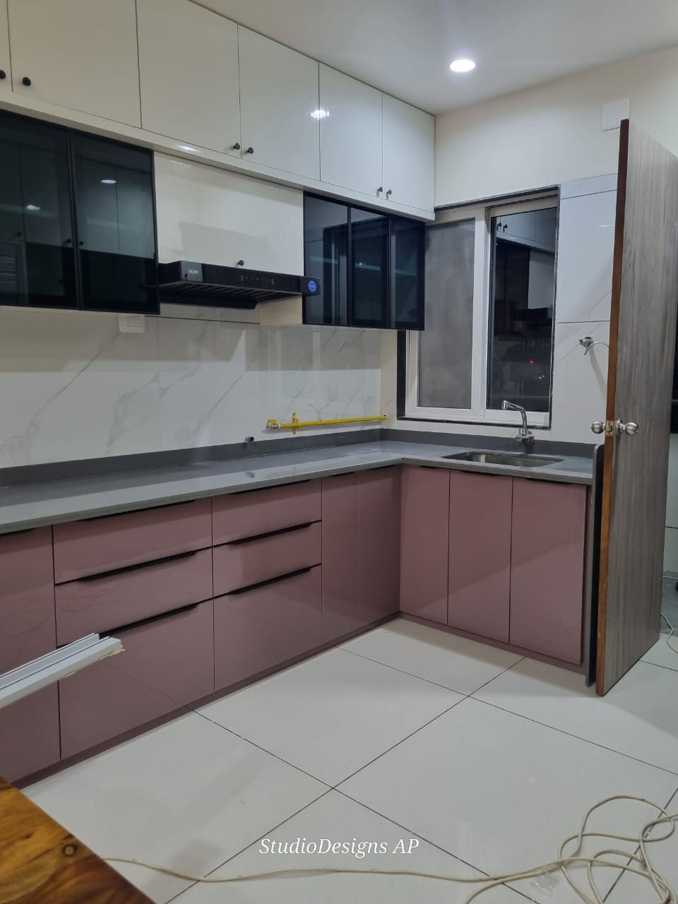 Modern L-Shaped Modular Kitchen with Black and White Cabinets - Studio Designs