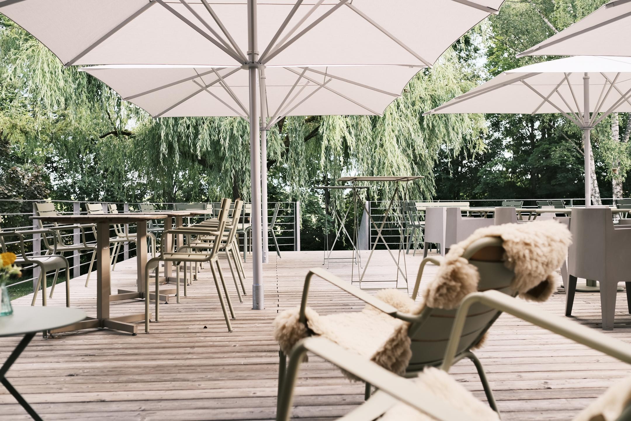 A terrace with white parasols