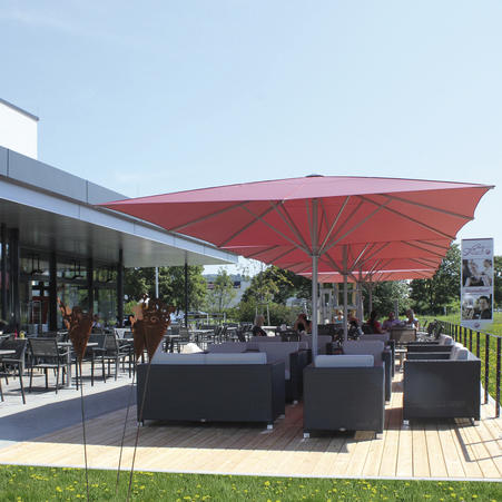 McDonalds McCafé in Munich. Green MAY Parasols with the golden McDonalds logo on the canopy.