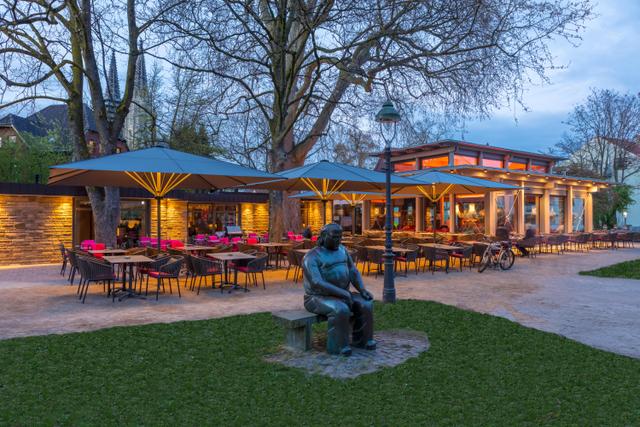 Grey giant parasols in front of a restaurant on its patio