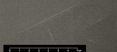 Grey textile with white stripes and measurements from 0 to 2.8 in