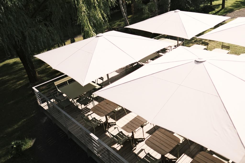 A terrace with white parasols
