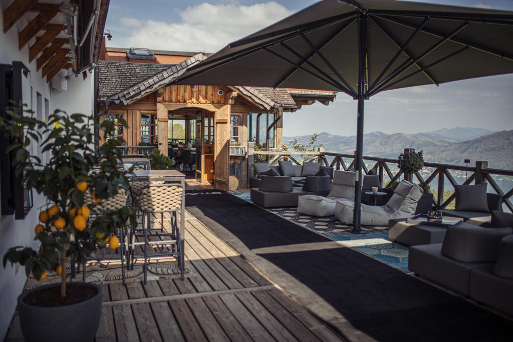 Gmundnerberghaus with gray ALBATROS umbrellas Wooden house with terrace and grey parasols