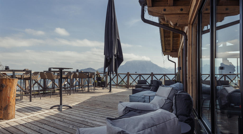 Gmundnerberghaus with gray ALBATROS umbrellas Wooden house with terrace and grey parasols