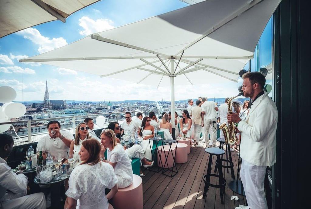 Roof terrace with musicians and white parasols