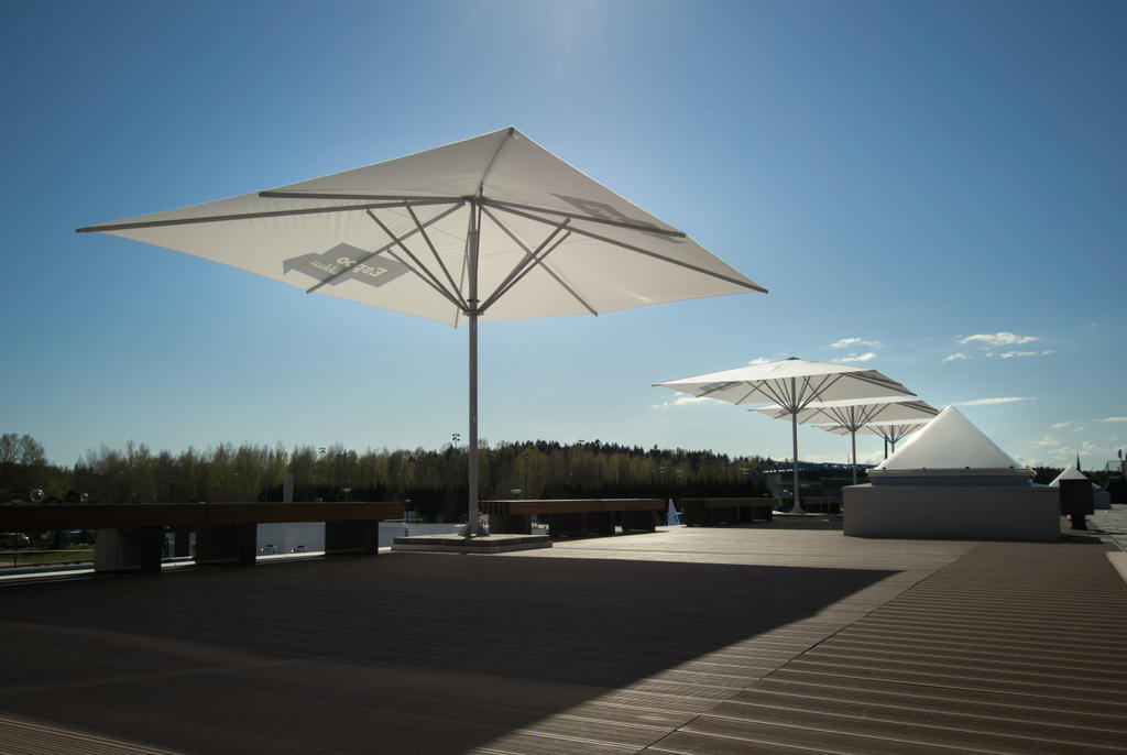 Leppävaara with white SCHATTELLO parasols Modern terrace with large white parasols.