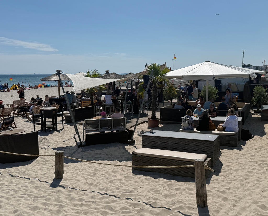 Beach restaurant with white parasols