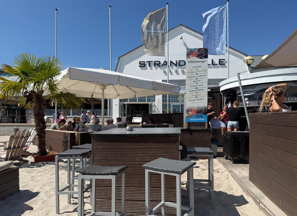 Beach restaurant with white parasols