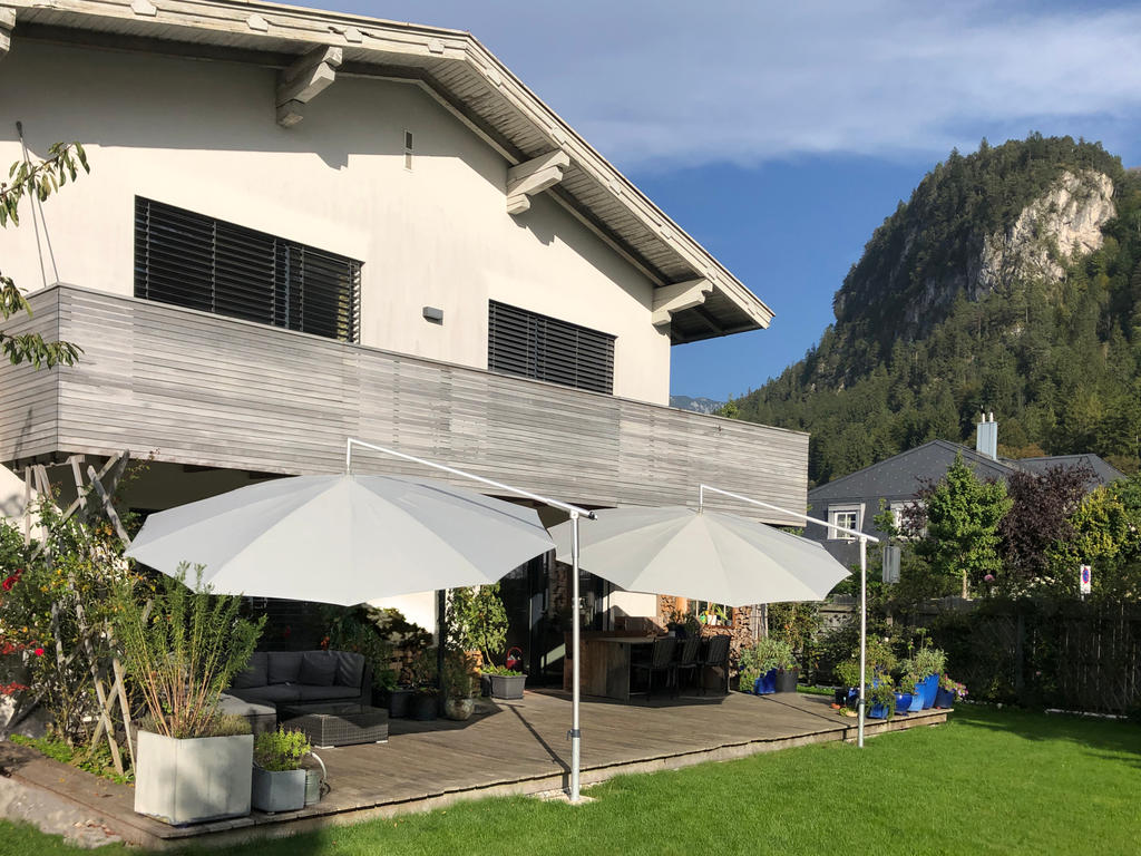 Terrace with two white parasols