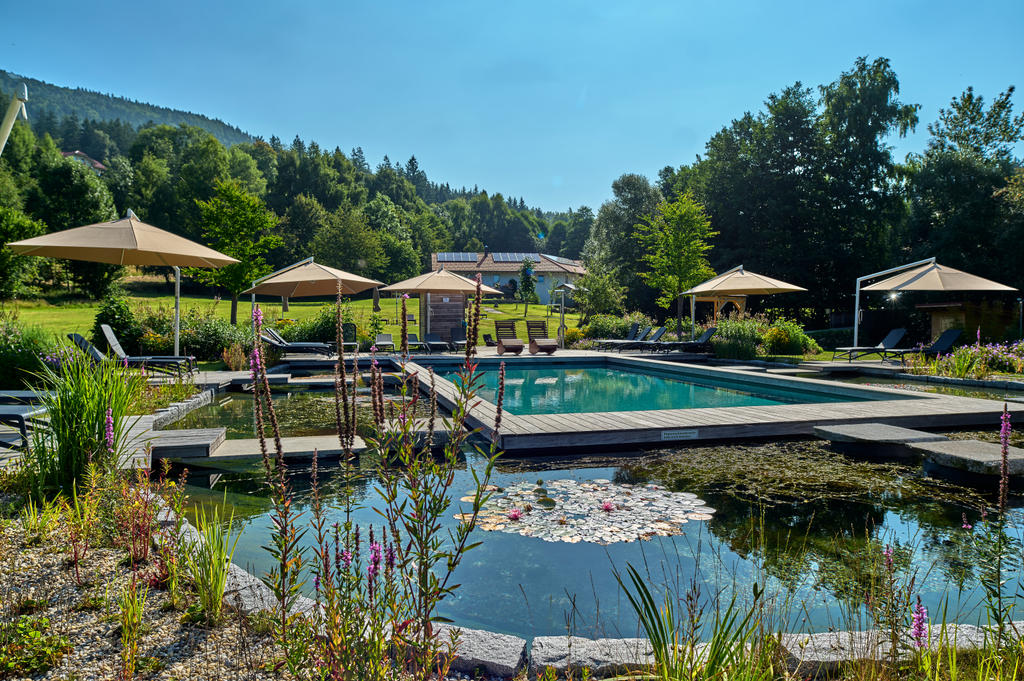Hotelgarten mit beigen Sonnenschirmen