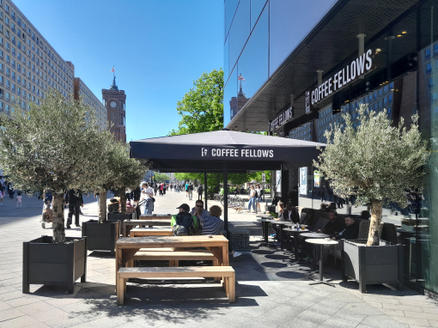 Parasol from Coffee Fellows offers shaded seating on the outdoor terrace