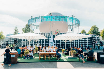 Flow Festival with outdoor seating area and white parasols.
