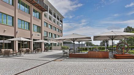 White Parasols create stylish shaded areas on the hotel terrace.