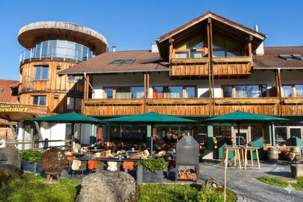 Hotel with green Parasols and sunny terrace in the mountains.