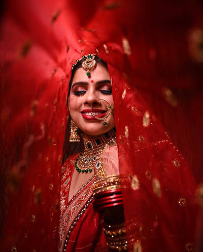 Artistic portrait of bride holding lotus flower
