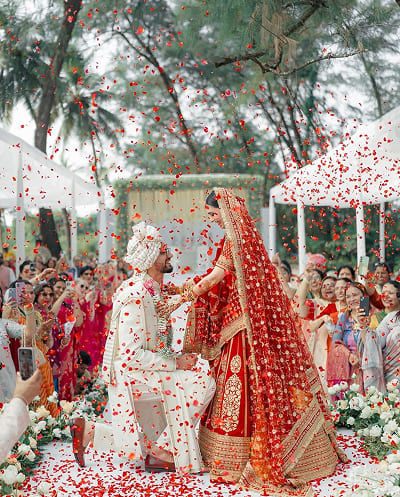 Couple wedding ritual with red flower shower