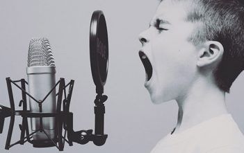 Understanding Audio – Part 1: The basic things you need to know Understanding Audio Boy Singing into Microphone