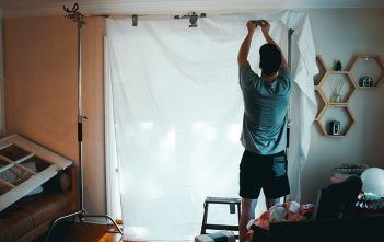 C Stand Facts, Misconceptions and Advanced Uses Man rigging a C Stand 1078 x 516