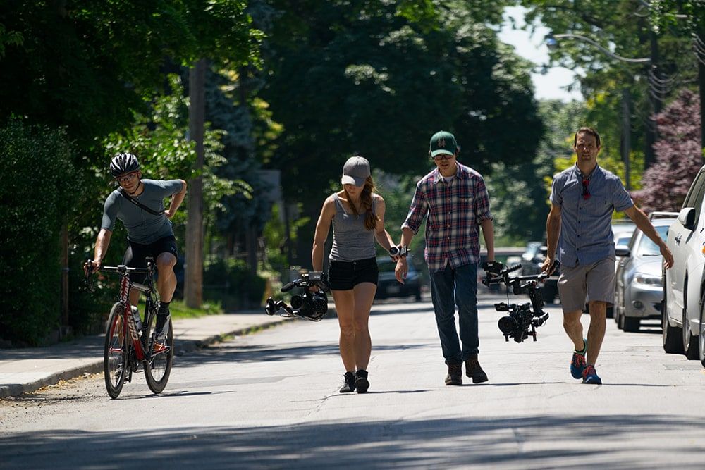 Film crew walking down the road