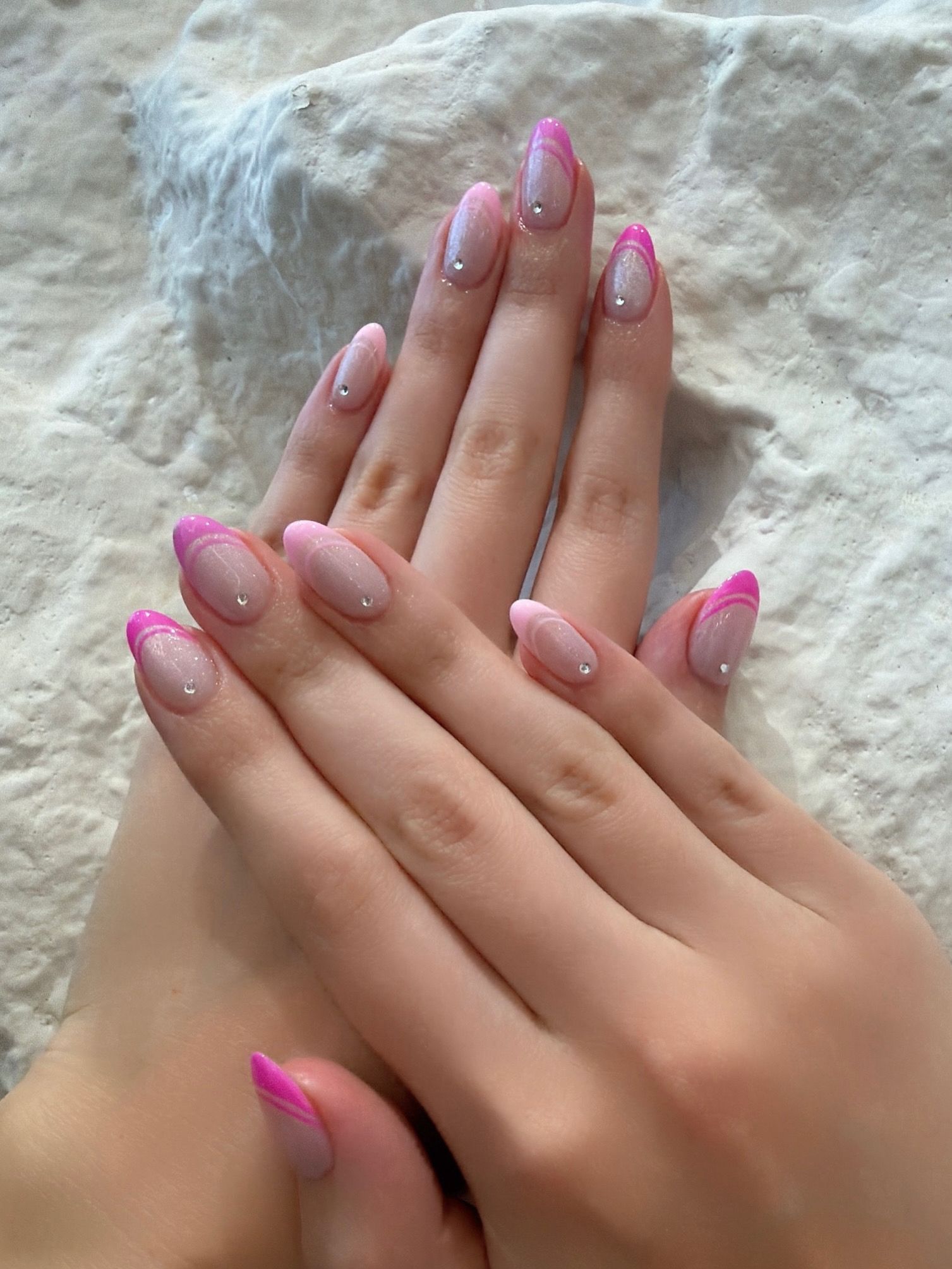 Pink double French almond nails with delicate crystal accents
