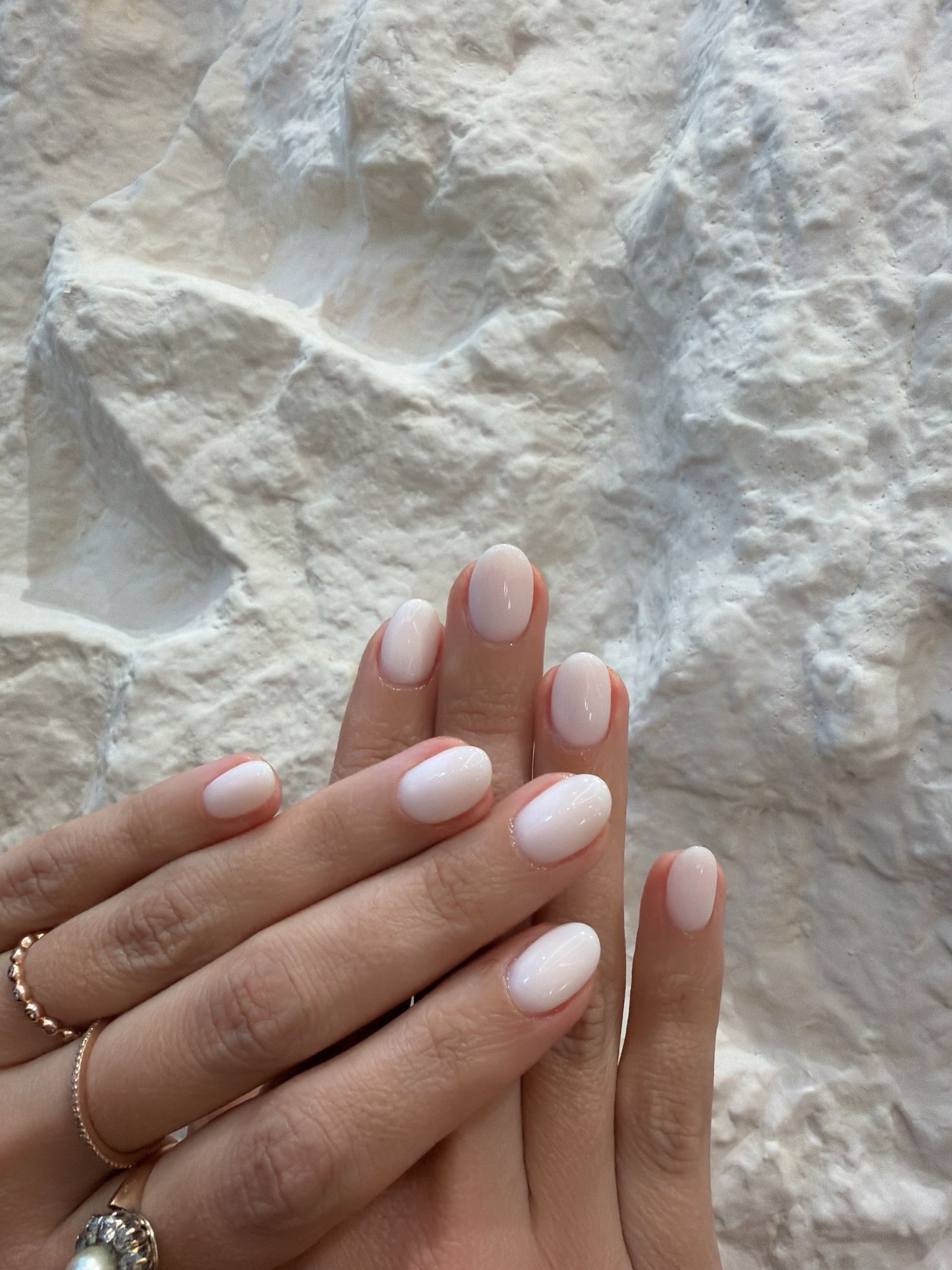 Short rounded nails finished in a clean milky white gloss