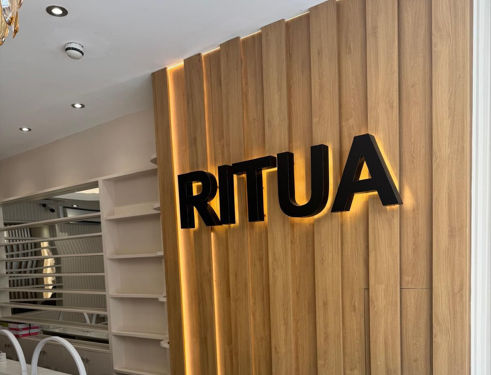 RITUA HOUSE warm wood feature wall and calm waiting chairs