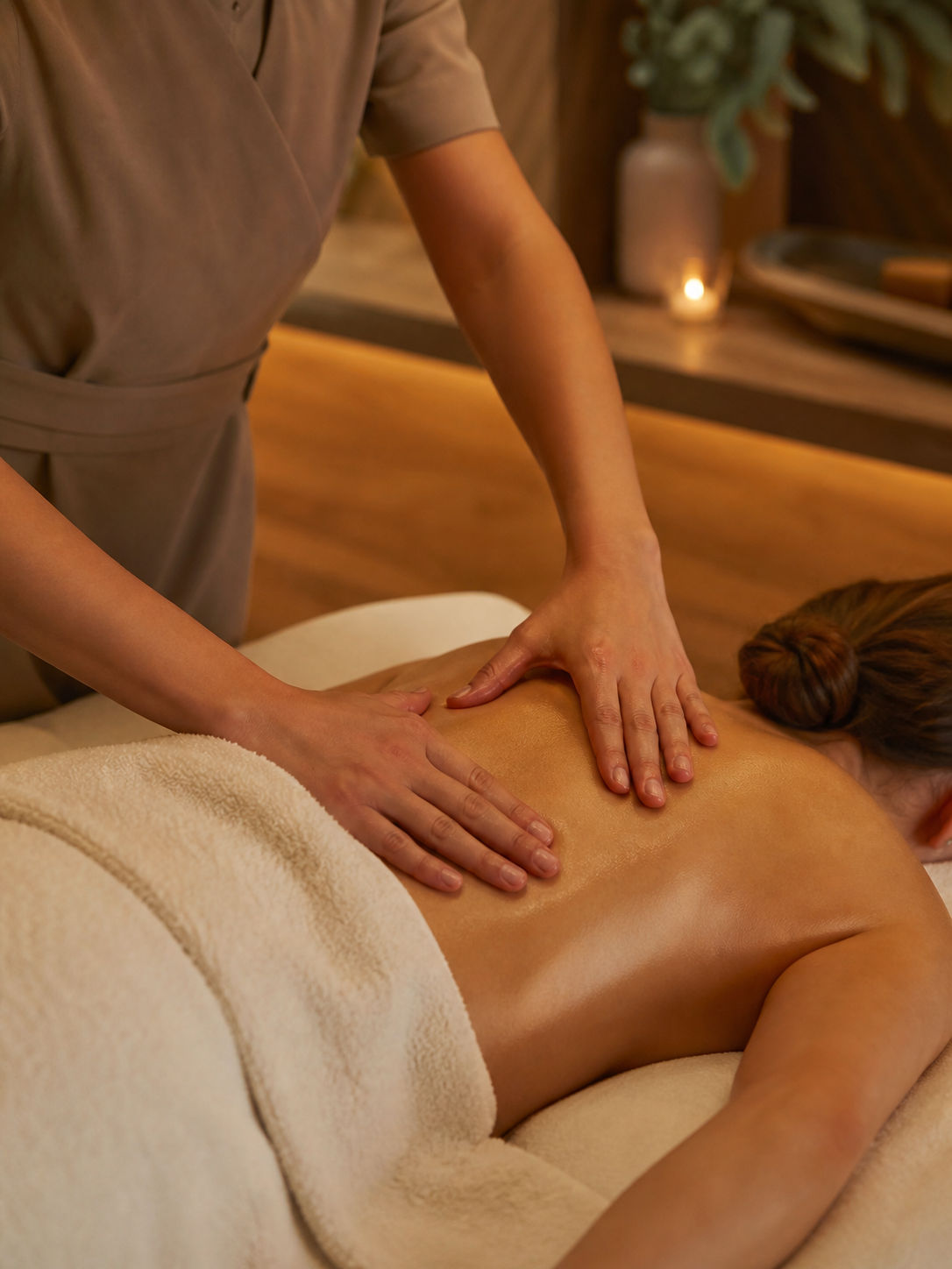 Calming back and shoulder massage in a warm treatment room