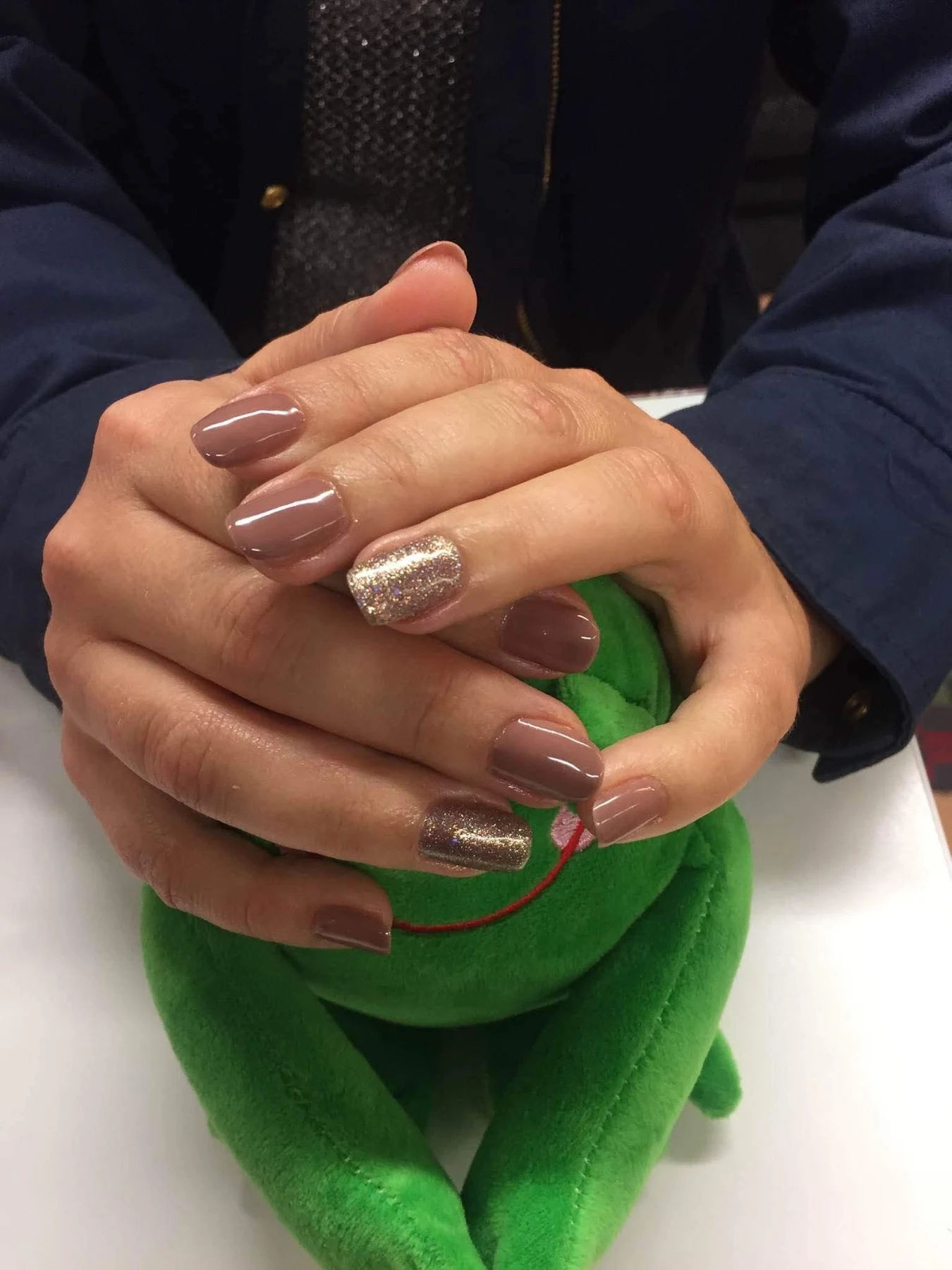 Nude manicure with glitter accent