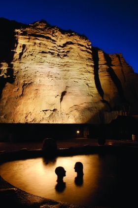 A couple relax in the Ojo Caliente waters