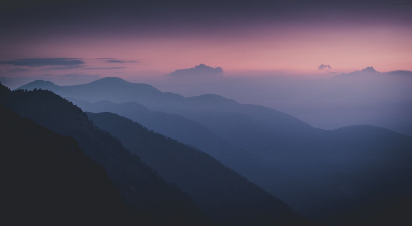 Mountain peaks in pink and blue sunset