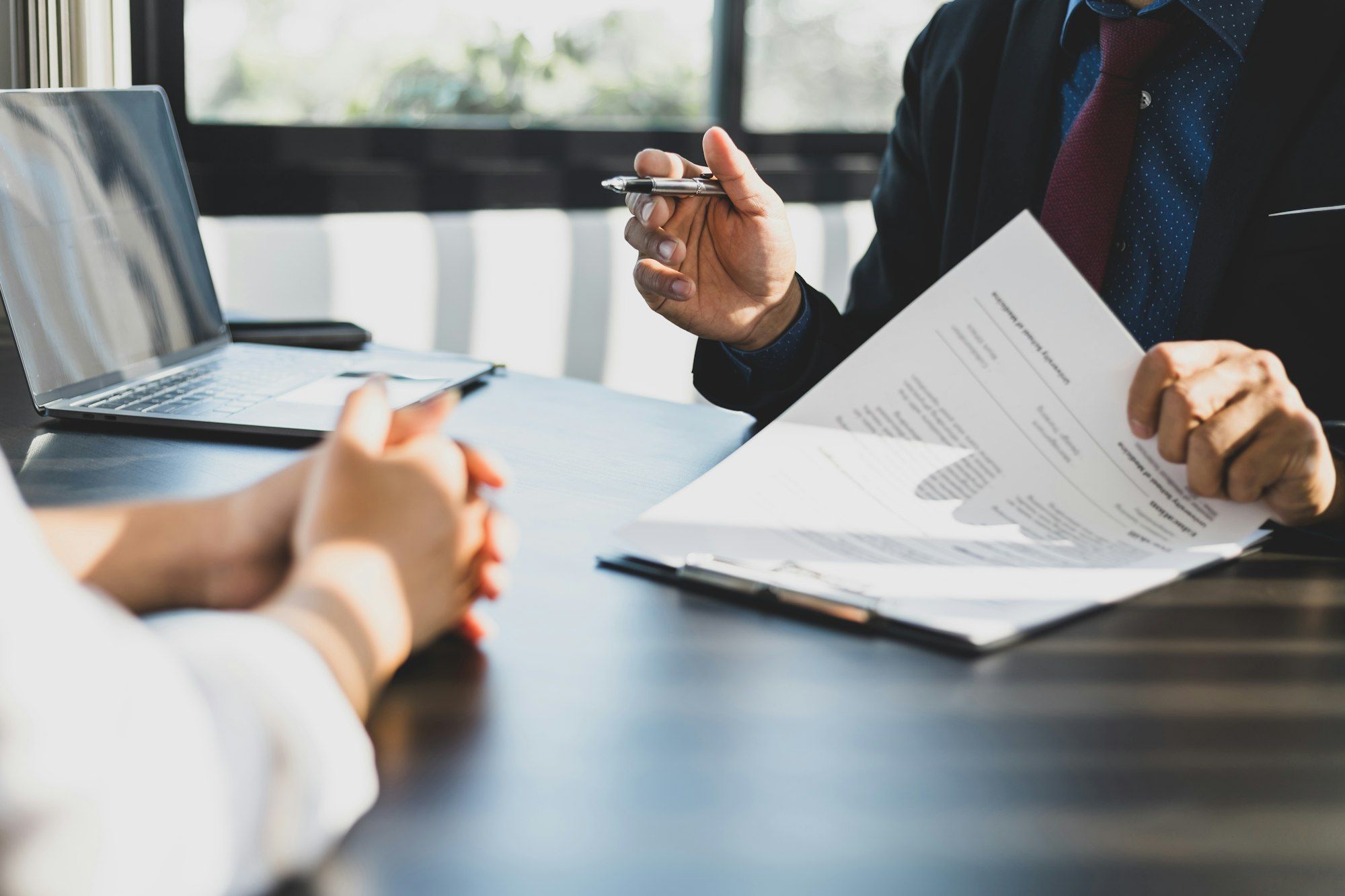 Businessman showing an insurance policy to sign. Insurance agent consulting insurance to customer.