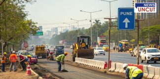Road widening work underway in Pune to improve traffic flow. Workers and construction machinery are engaged in road development, with traffic and city buildings visible in the background. A directional sign indicating Pune is also seen in the image.