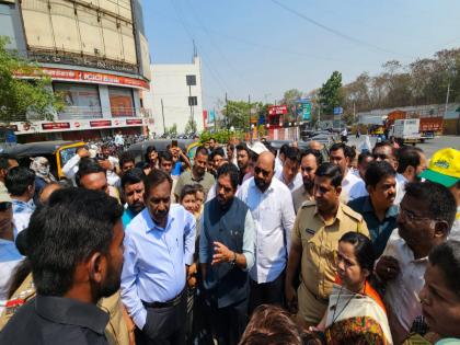 MLA Yogesh Tilekar and local authorities inspecting the Katraj Flyover construction site in Pune, surrounded by officials, police personnel, and citizens, discussing project progress and road development plans.