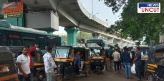 Swargate Bus Stand in Pune with a crowded scene of auto-rickshaws and passengers. Male rickshaw drivers are seen engaging with commuters, while buses and an elevated flyover are visible in the background. The busy transport hub reflects daily commuting activity in the city.