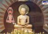 An idol of Bhagwan Mahavir in a Jain temple, surrounded by golden ornaments, with the Jain symbol and the phrase 'परस्परोपग्रहो जीवानाम्' inscribed. The backdrop features a decorative sunburst pattern, creating a serene and spiritual atmosphere.