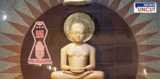 An idol of Bhagwan Mahavir in a Jain temple, surrounded by golden ornaments, with the Jain symbol and the phrase 'परस्परोपग्रहो जीवानाम्' inscribed. The backdrop features a decorative sunburst pattern, creating a serene and spiritual atmosphere.