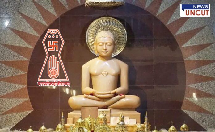 An idol of Bhagwan Mahavir in a Jain temple, surrounded by golden ornaments, with the Jain symbol and the phrase 'परस्परोपग्रहो जीवानाम्' inscribed. The backdrop features a decorative sunburst pattern, creating a serene and spiritual atmosphere.