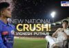 A stadium at night with bright floodlights and fireworks in the sky. On the left, a young cricketer in a Mumbai Indians jersey looks ahead with focus. On the right, the same person is sitting casually in a white outfit, smiling. Bold text in the center reads 'New National Crush! Vignesh Puthur.' The scene captures his rising fame and viral popularity.