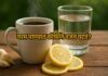 Steaming cup of black coffee with a glass of warm water, fresh lemon slices, and garlic cloves on a rustic wooden table, healthy morning setup.