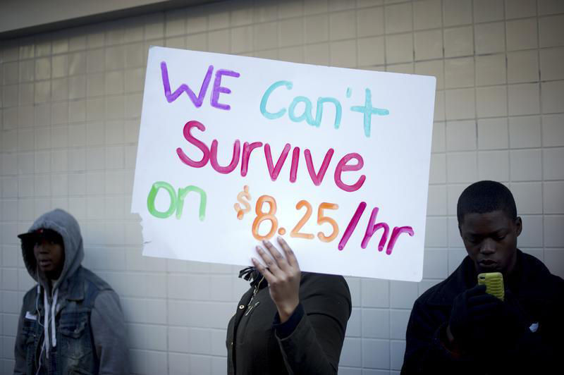 Protesters calling for higher wages for fast-food workers stand outside a McDonald's restaurant in Oakland