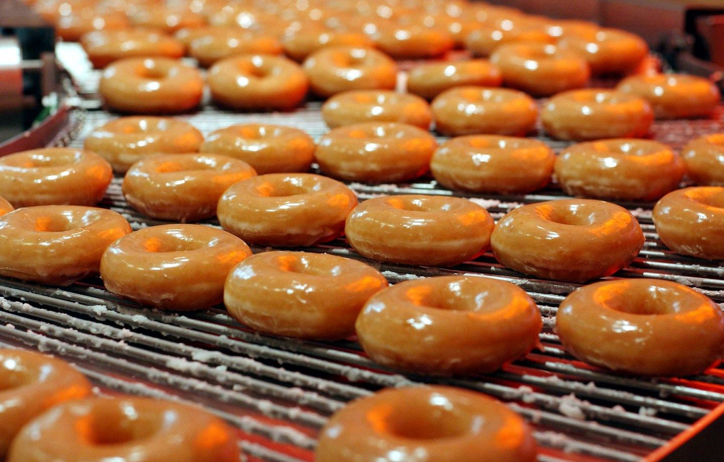 Krispy Kreme doughnuts go into production at the opening of the store at Harrods in London, October,..