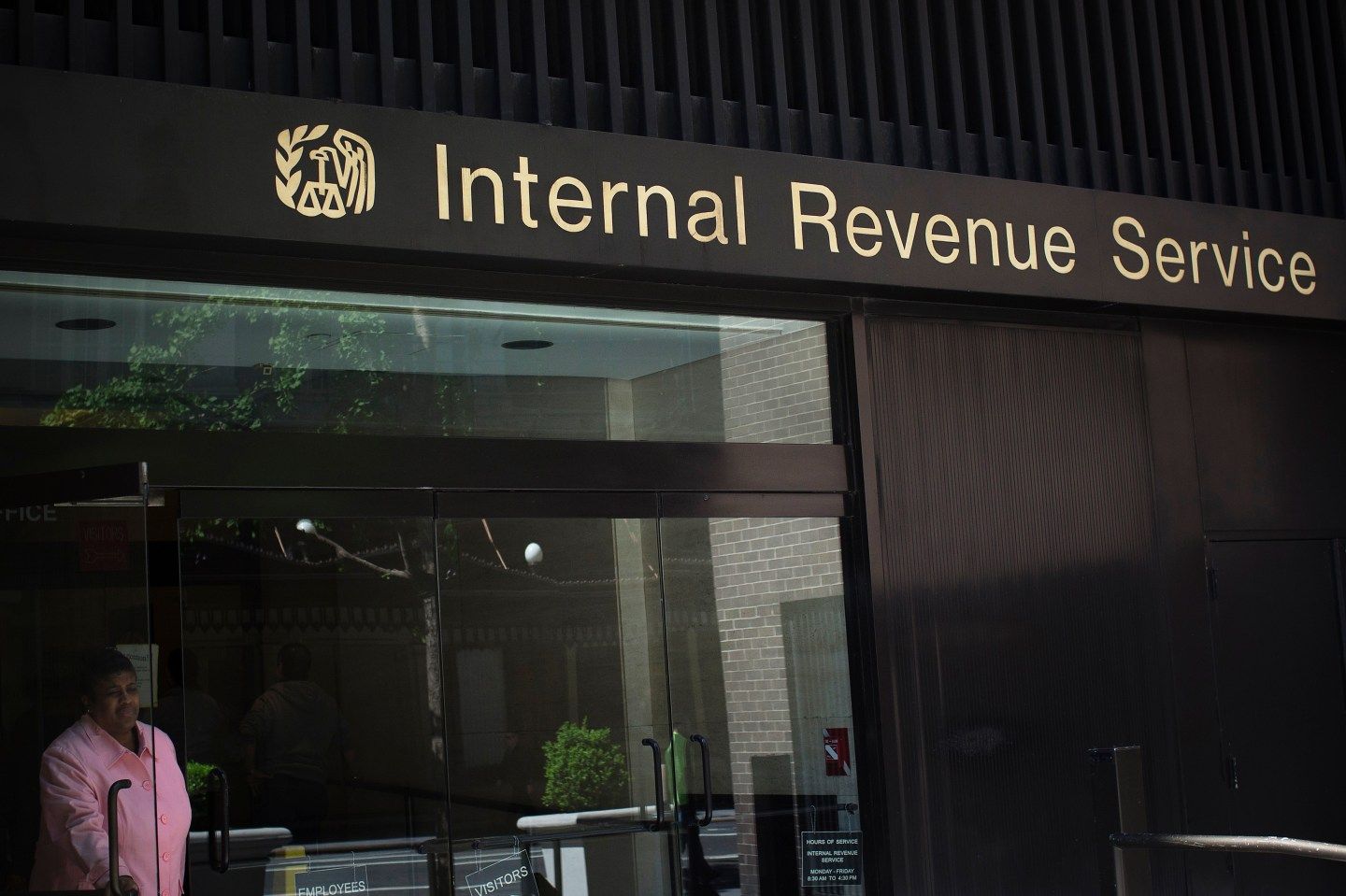 A woman walks out of the Internal Revenue Service building in New York