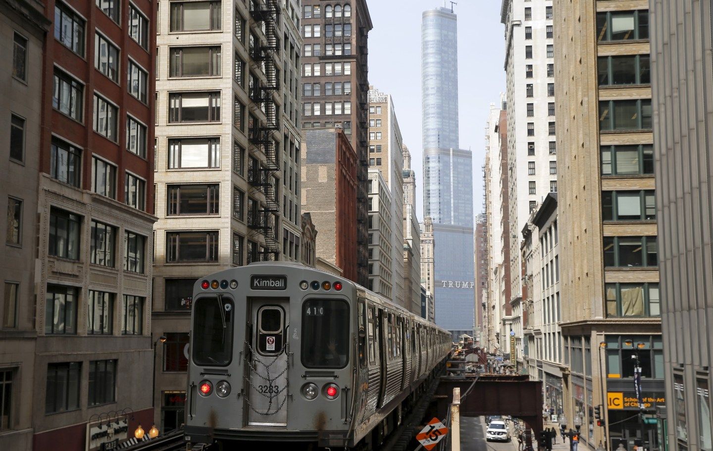 A subway car rides along the tracks towards The Trump International Hotel and Tower in downtown Chicago