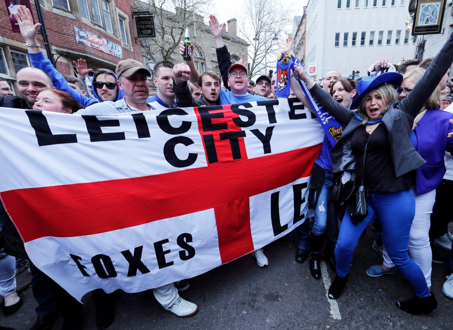 Leicester City fans celebrate in the street after their team's away soccer match against Manchester United, outside Hogarth's pub in Leicester
