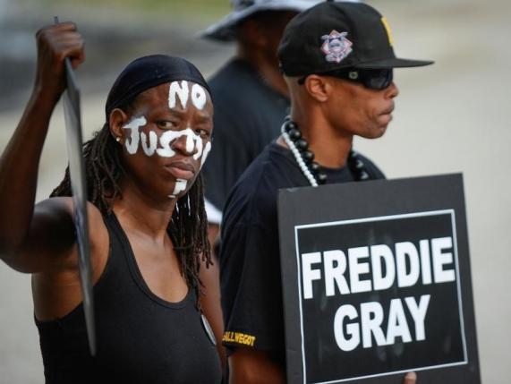 Selah and local artist PFK Boom gather to remember Freddie Gray and all victims of police violence during a rally outside city hall in Baltimore