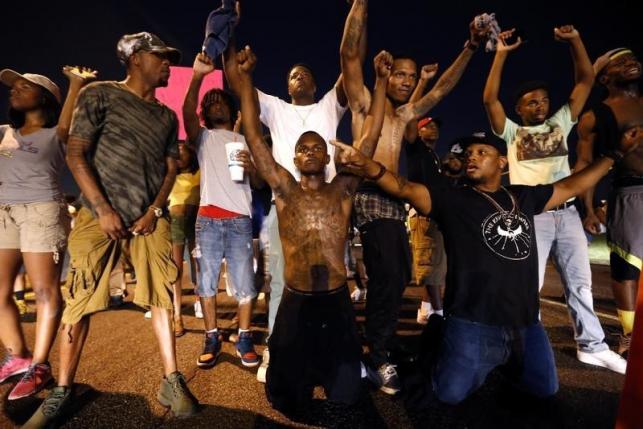 Demonstrators block traffic to protest the shooting death of Alton Sterling near the headquarters of the Baton Rouge Police Department in Baton Rouge, Louisiana