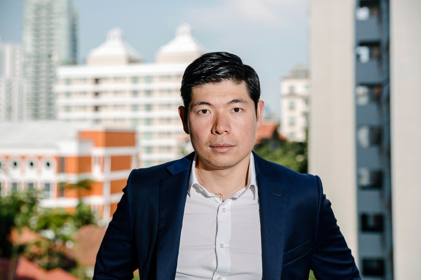 Anthony Tan, founder of GrabTaxi, stands on the balcony of his new home overlooking the cityscape of Singapore. The company is currently one of the big startup success stories of Southeast Asia. Tan founded the company in 2012 in Malaysia. Today the taxi app is available in 21 cities across the region, and has raised a total of US$340 million in funding.