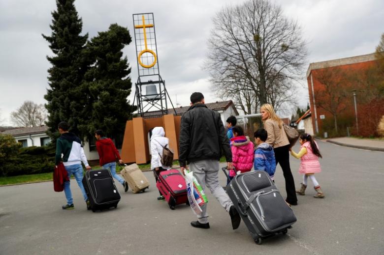 Syrian refugees arrive at the camp for refugees and migrants in Friedland